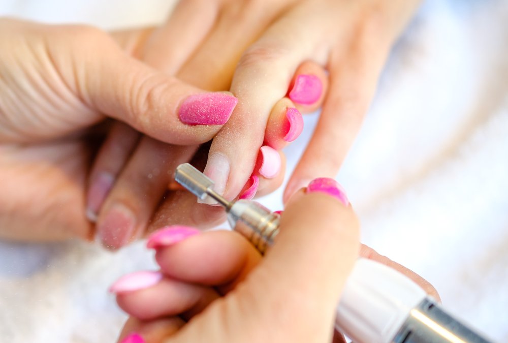 Woman,In,Nail,Salon,Receiving,Manicure,In,Beauty,Salon,By shutterstock 1716981640